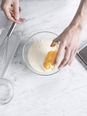 The baker combining the ingredients for the custard