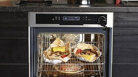 Chicken roasting perfectly in a steam oven