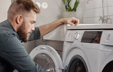 technician repairing an electrolux washing machine