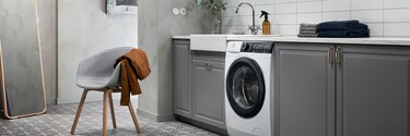 An Electrolux washing machine in a grey utility room
